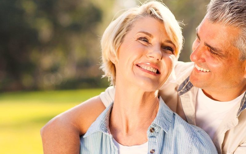 A couple smiling with relief outdoors