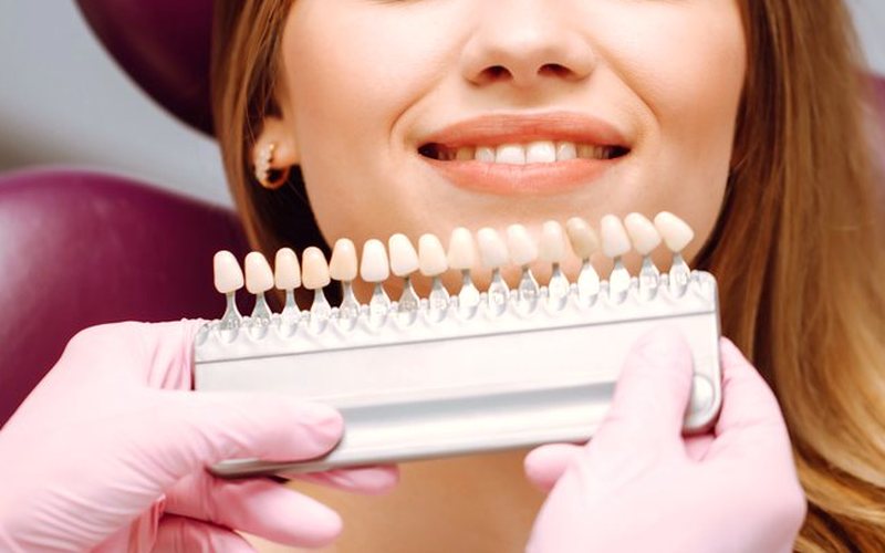 Dentist reviewing a tooth X-ray with a patient
