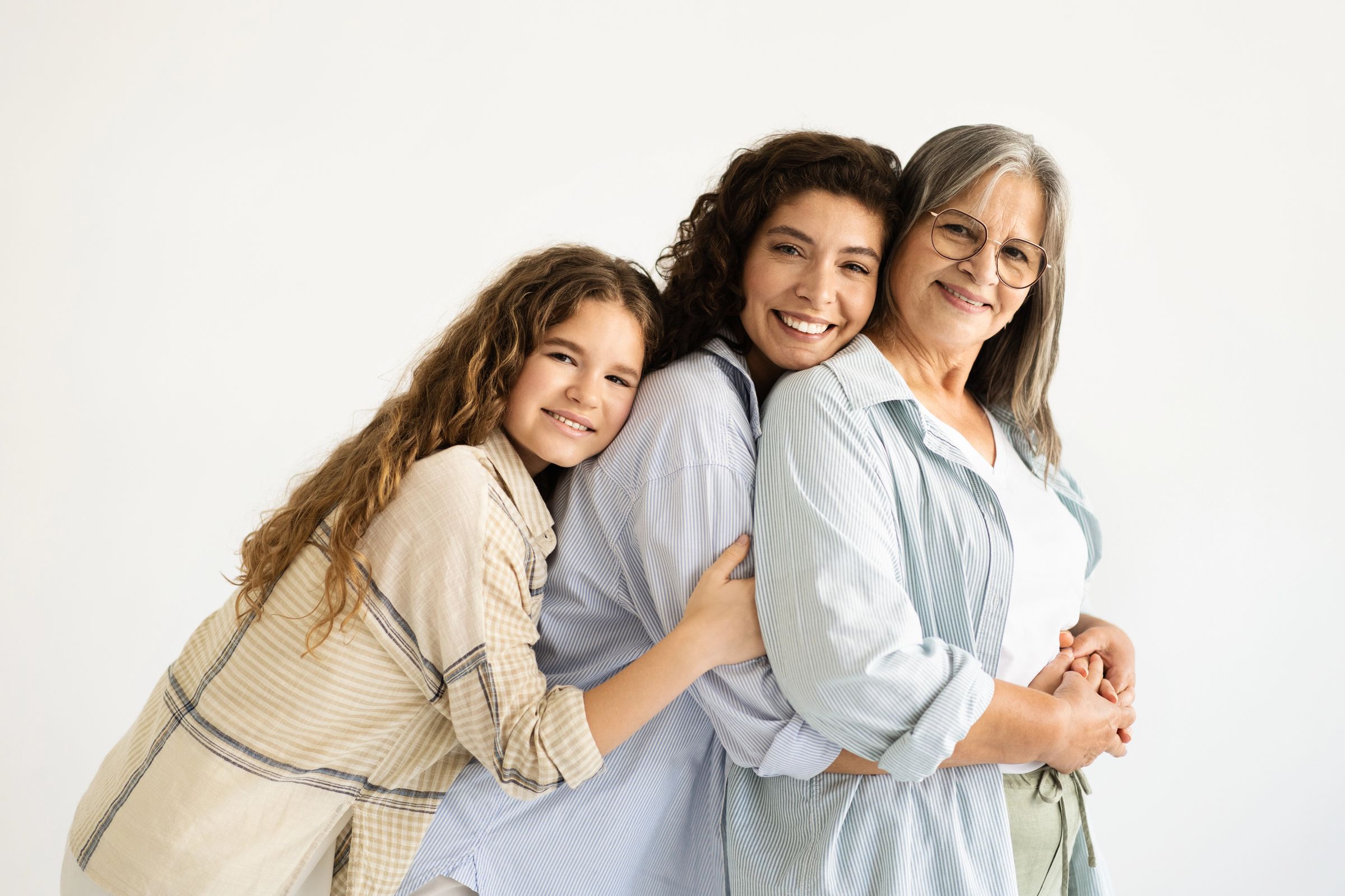 Three generations of one family, a girl, her mother, and grandmother, smiling together